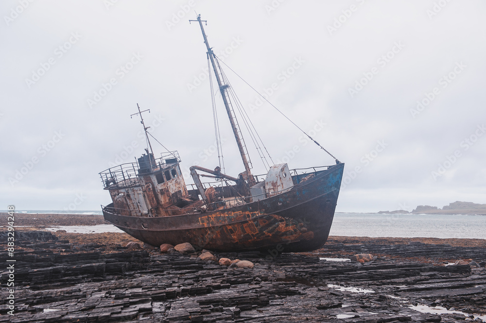 Derelict boat grounded on the shore, a haunting scene of maritime exploration Derelict boat grounded on the shore, a haunting scene of maritime exploration