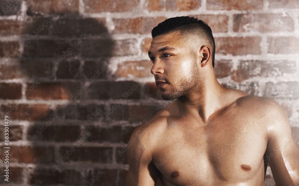 Fototapeta premium Shirtless, thinking and man in gym for fitness, wellness and health with workout routine for muscular body. Training center, male bodybuilder and confidence for exercise, commitment and wellbeing