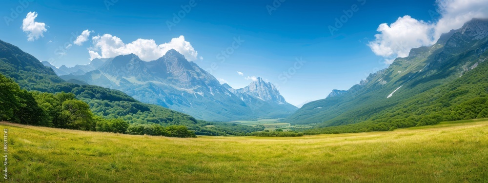 A verdant valley encircled by mountains beneath a blue sky dotted with white clouds, scattered few A verdant valley encircled by mountains beneath a blue sky dotted with white clouds, scattered few