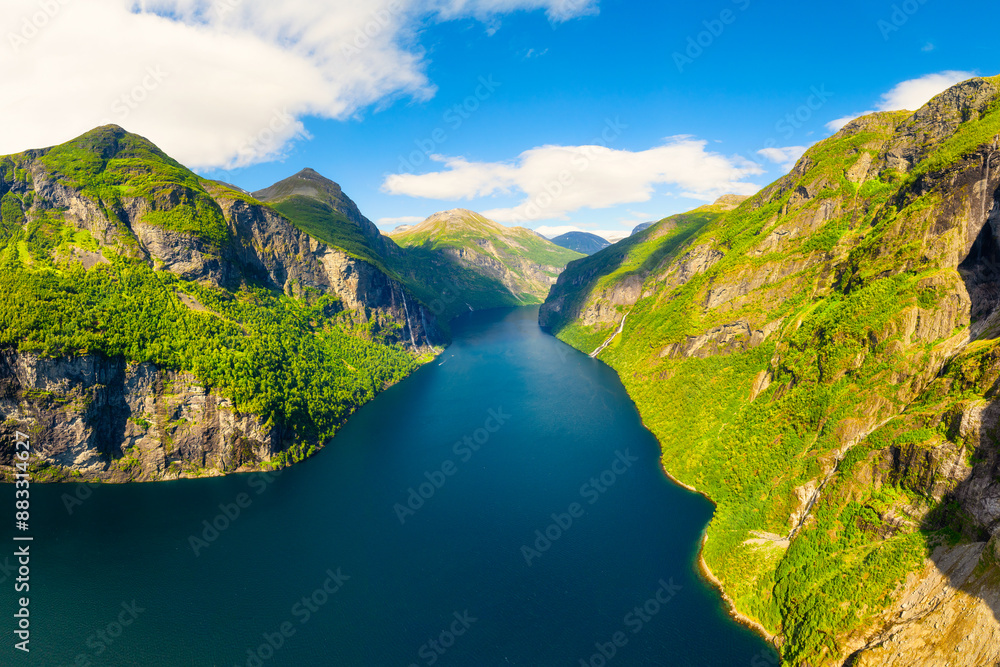 Geiranger Fjord, Norway. Nature in fjords. Traveling by boat on a Norwegian fjord. Scandinavia. View of nature from the drone. Seven Sisters Waterfall. Vacation and travel in summer Norway.