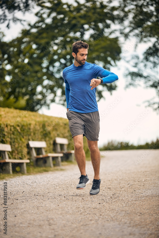 Running, timer and man on road for fitness, cardio and check heartbeat on pathway. Male athlete, jogging and counting steps in nature for distance, marathon challenge and aerobic activity in Italy Running, timer and man on road for fitness, cardio and check heartbeat on pathway. Male athlete, jogging and counting steps in nature for distance, marathon challenge and aerobic activity in Italy
