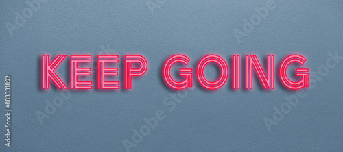 Keep going neon sign on a wall photo