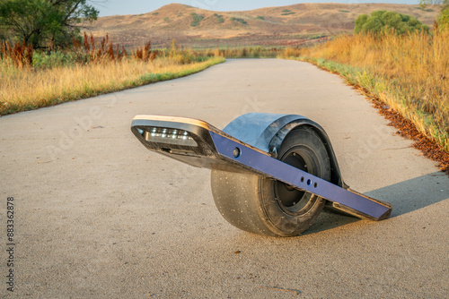 one-wheeled electric skateboard on a bike trail photo