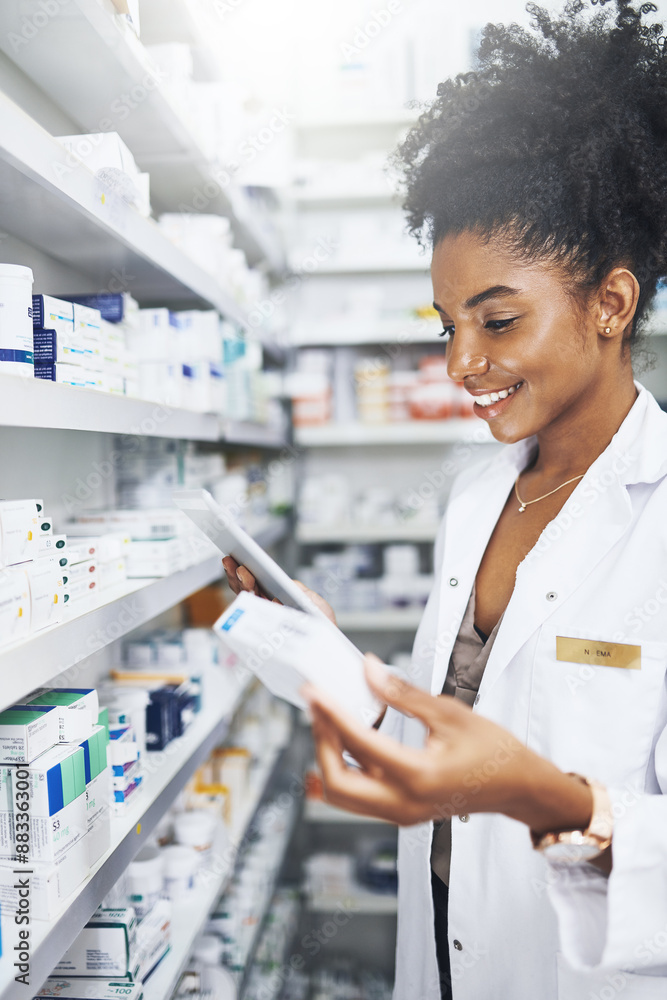 © peopleimages.com - Black woman, tablet and check drugs at pharmacy for stock, inventory or reading label on box at shelf. Tech, smile and medical pharmacist with medicine for online prescription order, info or health