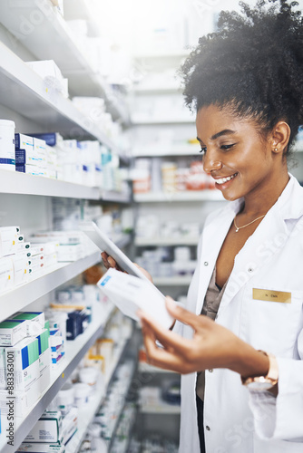 Black woman, tablet and check drugs at pharmacy for stock, inventory or reading label on box at shelf. Tech, smile and medical pharmacist with medicine for online prescription order, info or health