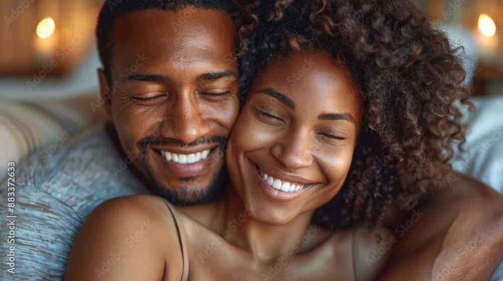 A heartwarming moment captured in a close-up photo of a couple embracing each other with genuine smiles against a cozy background illuminated by soft lighting A heartwarming moment captured in a close-up photo of a couple embracing each other with genuine smiles against a cozy background illuminated by soft lighting