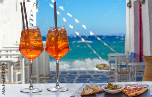 Fototapeta Naklejka Na Ścianę i Meble -  two aperol spritz with appetizer in a bar on the Greek island of Mykonos