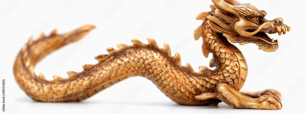 Obraz premium A golden dragon figurine sits atop a white surface with its mouth agape
