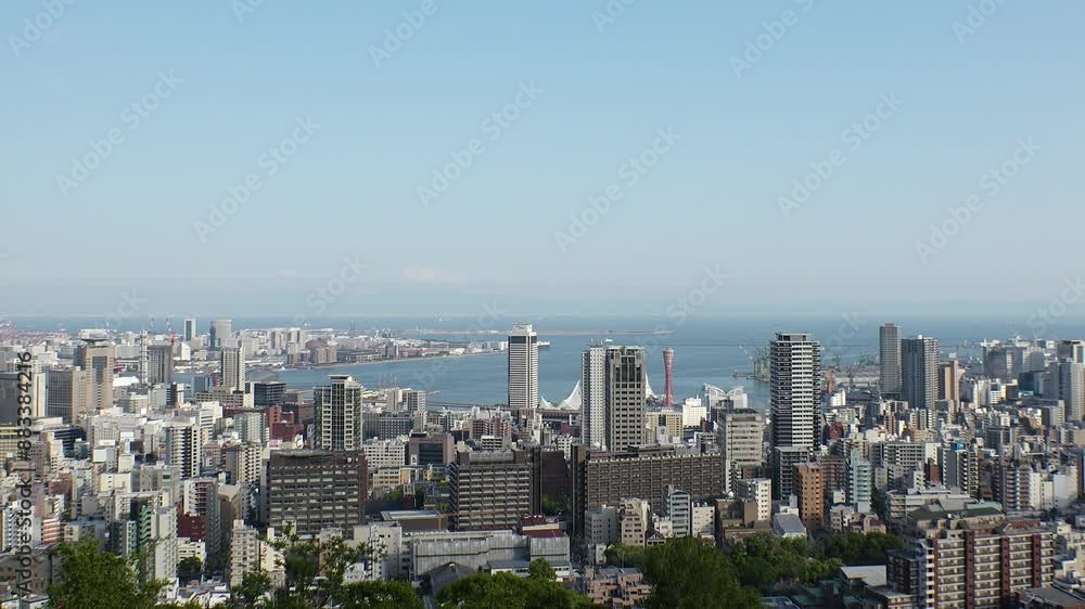 KOBE, HYOGO, JAPAN - JUNE 2024 : Aerial high angle view of Kobe city and Kobe port in daytime. View of buildings and street around Kobe port tower and Sannomiya station. 4K time lapse shot. KOBE, HYOGO, JAPAN - JUNE 2024 : Aerial high angle view of Kobe city and Kobe port in daytime. View of buildings and street around Kobe port tower and Sannomiya station. 4K time lapse shot.