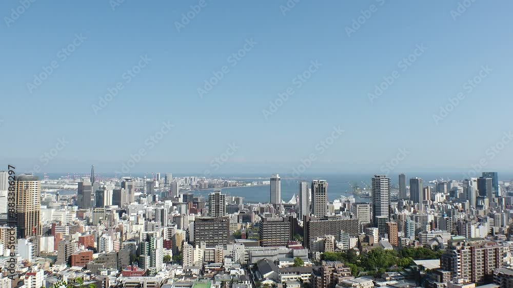 KOBE, HYOGO, JAPAN - JUNE 2024 : Aerial high angle view of Kobe city and Kobe port in daytime. View of buildings and street around Kobe port tower and Sannomiya station. 4K time lapse shot. KOBE, HYOGO, JAPAN - JUNE 2024 : Aerial high angle view of Kobe city and Kobe port in daytime. View of buildings and street around Kobe port tower and Sannomiya station. 4K time lapse shot.