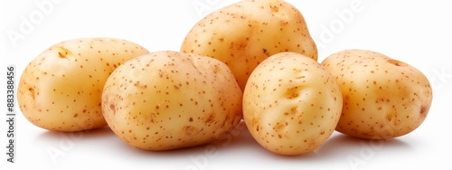  A stack of potatoes arranged neatly on a white table against a plain white backdrop