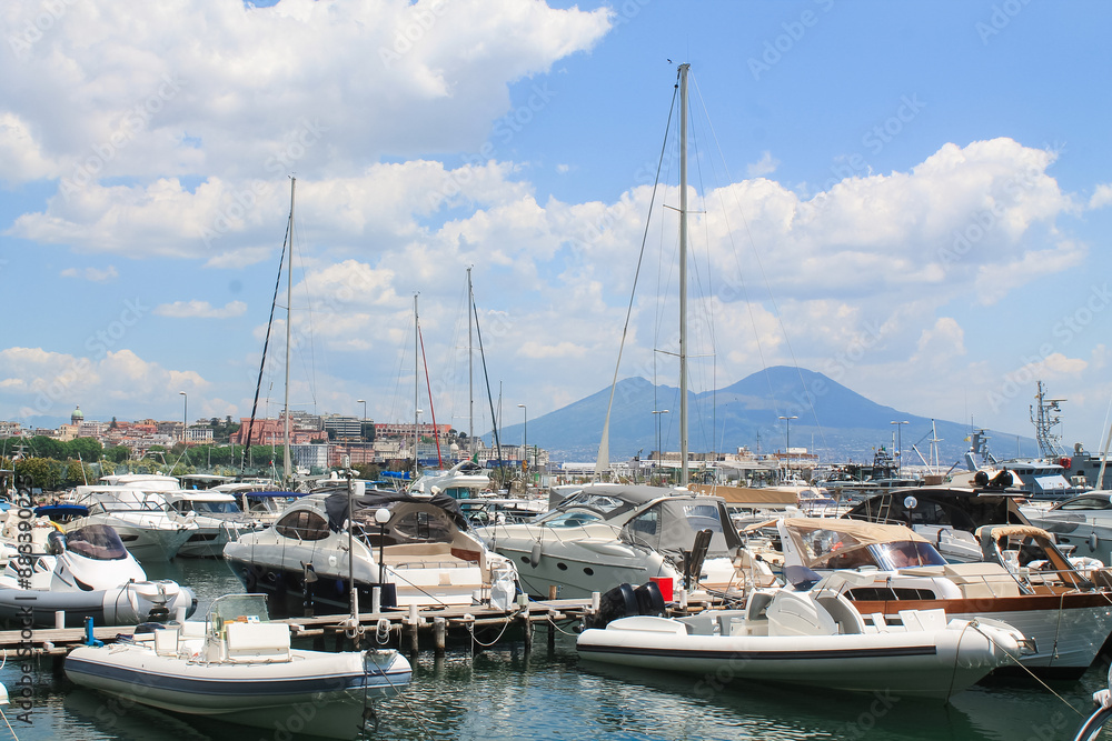 Boats in the marina. Beautiful white yachts parked on the sea coast on the mountains and Vesuvius volcano background, Naples, Italy Boats in the marina. Beautiful white yachts parked on the sea coast on the mountains and Vesuvius volcano background, Naples, Italy