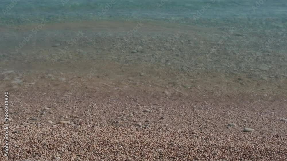 Calm rippling blue Mediterranean sea water above the seabed with white pebbles. Abstract water surface background Calm rippling blue Mediterranean sea water above the seabed with white pebbles. Abstract water surface background