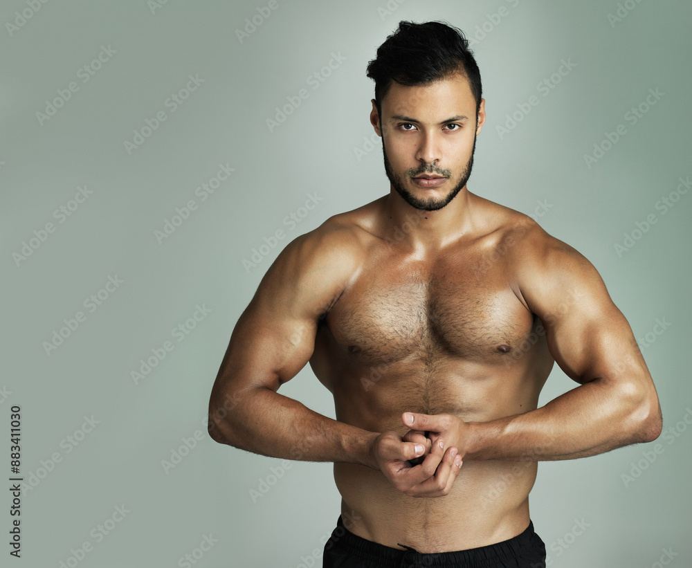 Serious man, portrait and fitness with flex for exercise, workout or training on a studio background. Muscular male person, athlete or young model with bicep in bodybuilding, strength or muscle gain Serious man, portrait and fitness with flex for exercise, workout or training on a studio background. Muscular male person, athlete or young model with bicep in bodybuilding, strength or muscle gain