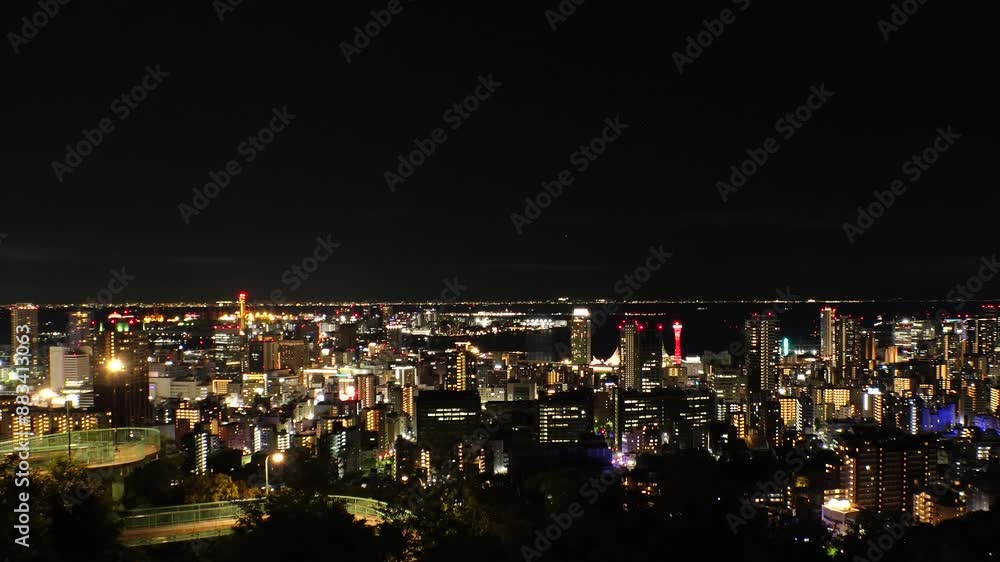 KOBE, HYOGO, JAPAN - JUNE 2024 : Aerial high angle view of Kobe city and Kobe port at night. View of buildings and street around Kobe port tower and Sannomiya station. 4K time lapse shot. KOBE, HYOGO, JAPAN - JUNE 2024 : Aerial high angle view of Kobe city and Kobe port at night. View of buildings and street around Kobe port tower and Sannomiya station. 4K time lapse shot.