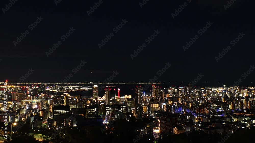 KOBE, HYOGO, JAPAN - JUNE 2024 : Aerial high angle view of Kobe city and Kobe port at night. View of buildings and street around Kobe port tower and Sannomiya station. 4K time lapse shot. KOBE, HYOGO, JAPAN - JUNE 2024 : Aerial high angle view of Kobe city and Kobe port at night. View of buildings and street around Kobe port tower and Sannomiya station. 4K time lapse shot.