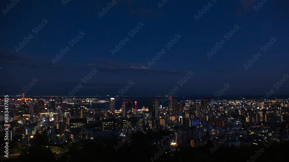 KOBE, HYOGO, JAPAN -JUN 2024 : Aerial high angle view of Kobe city and Kobe port in sunset. View of buildings and street around Kobe port tower and Sannomiya station. 4K time lapse shot, dusk to night KOBE, HYOGO, JAPAN -JUN 2024 : Aerial high angle view of Kobe city and Kobe port in sunset. View of buildings and street around Kobe port tower and Sannomiya station. 4K time lapse shot, dusk to night