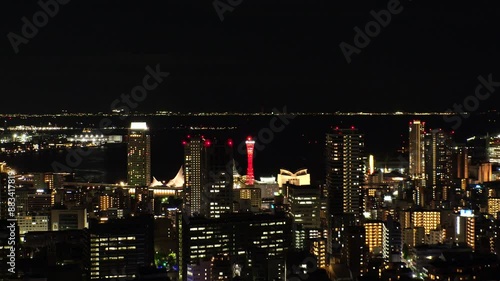 Wallpaper Mural KOBE, HYOGO, JAPAN - JUNE 2024 : Aerial high angle view of Kobe city and Kobe port at night. View of buildings and street around Kobe port tower and Sannomiya station. 4K time lapse shot. Torontodigital.ca