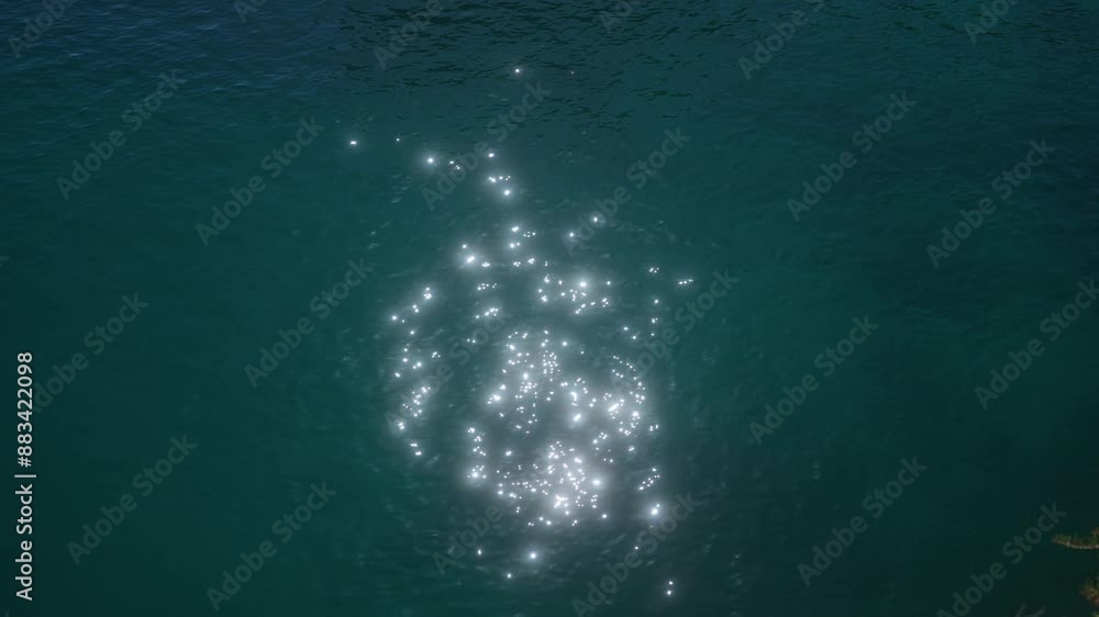Sunlight sparkles on the surface of clear, blue water, creating a mesmerizing pattern of light reflections outdoors. Sunlight sparkles on the surface of clear, blue water, creating a mesmerizing pattern of light reflections outdoors.