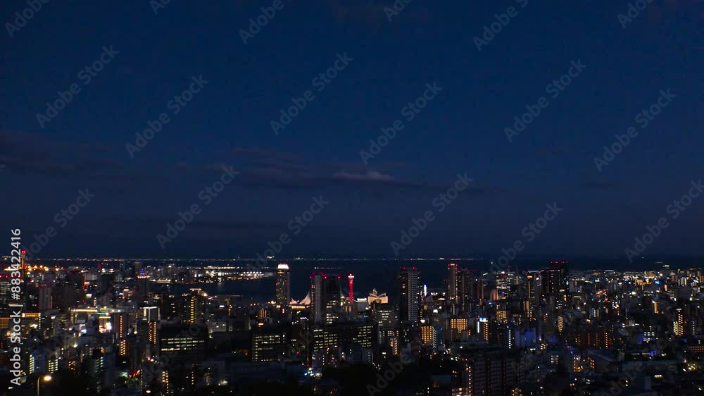 KOBE, HYOGO, JAPAN -JUN 2024 : Aerial high angle view of Kobe city and Kobe port in sunset. View of buildings and street around Kobe port tower and Sannomiya station. 4K time lapse shot, dusk to night KOBE, HYOGO, JAPAN -JUN 2024 : Aerial high angle view of Kobe city and Kobe port in sunset. View of buildings and street around Kobe port tower and Sannomiya station. 4K time lapse shot, dusk to night