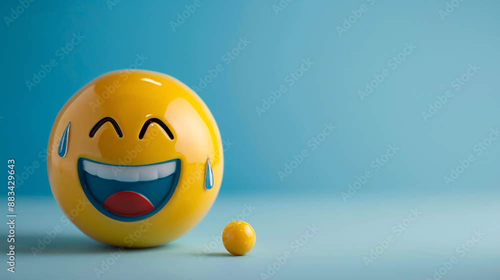 Fototapeta premium A laughing face emoji with tears of joy on a blue background