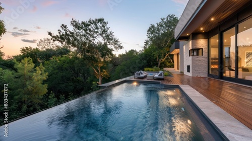 Wallpaper Mural Suburban Modern home's infinity pool with a floating deck, integrated lighting, and views of the surrounding nature Torontodigital.ca