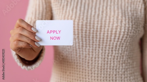 Hand holding a card with 'Apply Now' text, inviting and encouraging action. Ideal for recruitment and business opportunities. photo