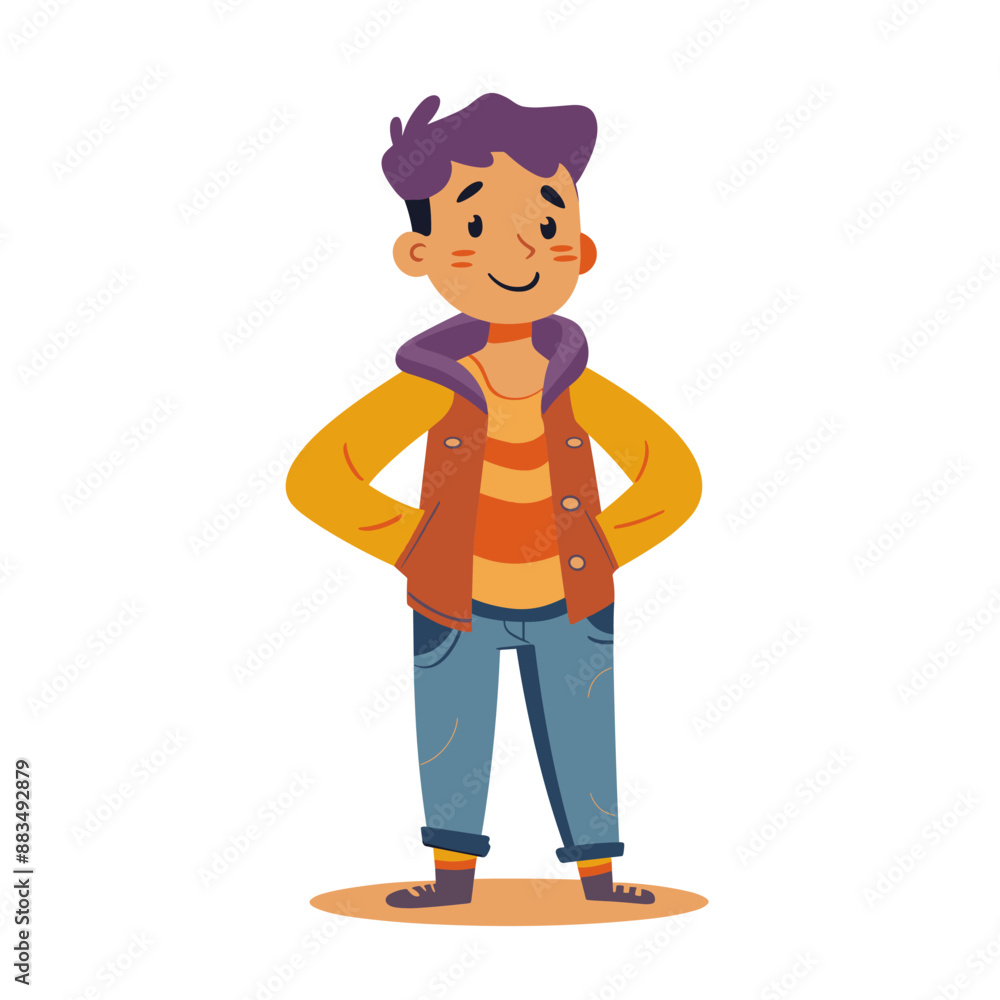 A young man in a yellow jacket and blue jeans stands with his arms crossed. He has a smile on his face A young man in a yellow jacket and blue jeans stands with his arms crossed. He has a smile on his face