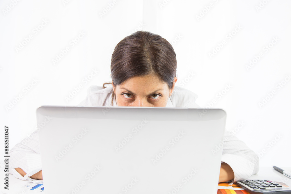 Businesswoman working with laptop looking at camera Businesswoman working with laptop looking at camera