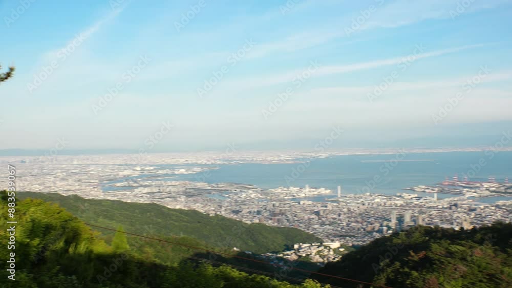 KOBE, HYOGO, JAPAN - JUNE 2024 : Aerial high angle panoramic view around Kobe city, Kobe port, Osaka city and Osaka bay in daytime. View from top of Rokkosan (Mt. Rokko). KOBE, HYOGO, JAPAN - JUNE 2024 : Aerial high angle panoramic view around Kobe city, Kobe port, Osaka city and Osaka bay in daytime. View from top of Rokkosan (Mt. Rokko).