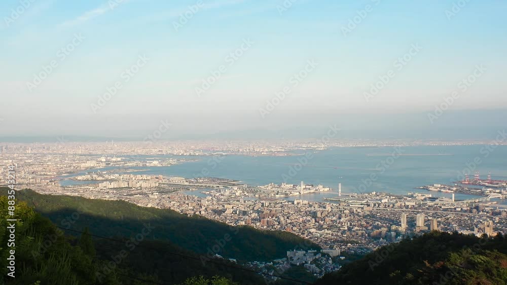 KOBE, HYOGO, JAPAN - JUN 2024 : Aerial high angle panoramic view around Kobe city, Kobe port, Osaka city and Osaka bay. View from top of Rokkosan (Mt. Rokko). Time lapse shot in sunset. KOBE, HYOGO, JAPAN - JUN 2024 : Aerial high angle panoramic view around Kobe city, Kobe port, Osaka city and Osaka bay. View from top of Rokkosan (Mt. Rokko). Time lapse shot in sunset.