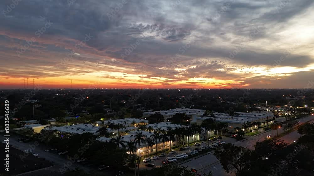 A stunning hyper-lapse aerial view of Hollywood, Florida at sunset, captured by a drone. The scene showcases a busy street filled with cars. A stunning hyper-lapse aerial view of Hollywood, Florida at sunset, captured by a drone. The scene showcases a busy street filled with cars.