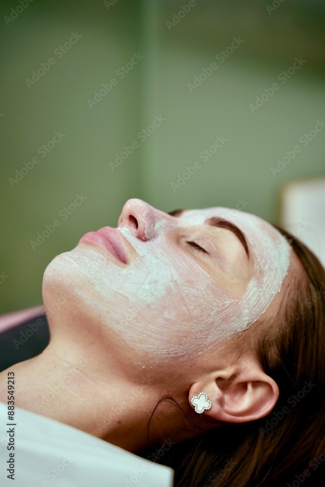A beautician performs cosmetic procedures on a girl's face A beautician performs cosmetic procedures on a girl's face