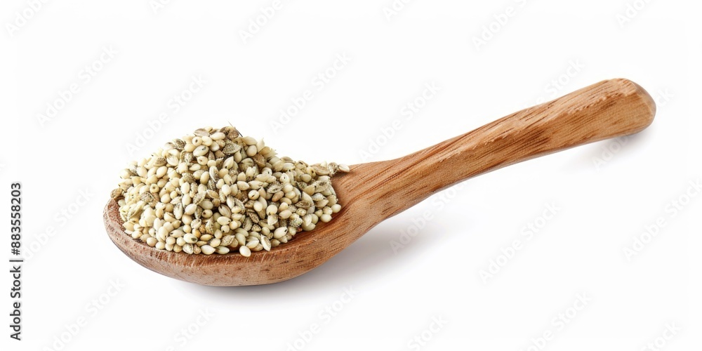 A wooden spoon filled with seeds on a white surface A wooden spoon filled with seeds on a white surface