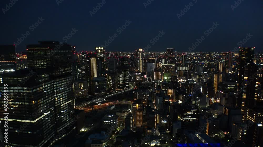 UMEDA, OSAKA, JAPAN - JUNE 2024 : Aerial high angle view around Osaka train station at night. View of crowded buildings at downtown area. Japanese urban city and business concept video. UMEDA, OSAKA, JAPAN - JUNE 2024 : Aerial high angle view around Osaka train station at night. View of crowded buildings at downtown area. Japanese urban city and business concept video.