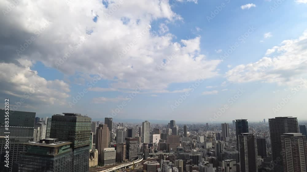 UMEDA, OSAKA, JAPAN - JUNE 2024 : Aerial high angle view around Osaka train station in daytime. View of crowded buildings at downtown area. Urban city and business concept video. Time lapse shot. UMEDA, OSAKA, JAPAN - JUNE 2024 : Aerial high angle view around Osaka train station in daytime. View of crowded buildings at downtown area. Urban city and business concept video. Time lapse shot.