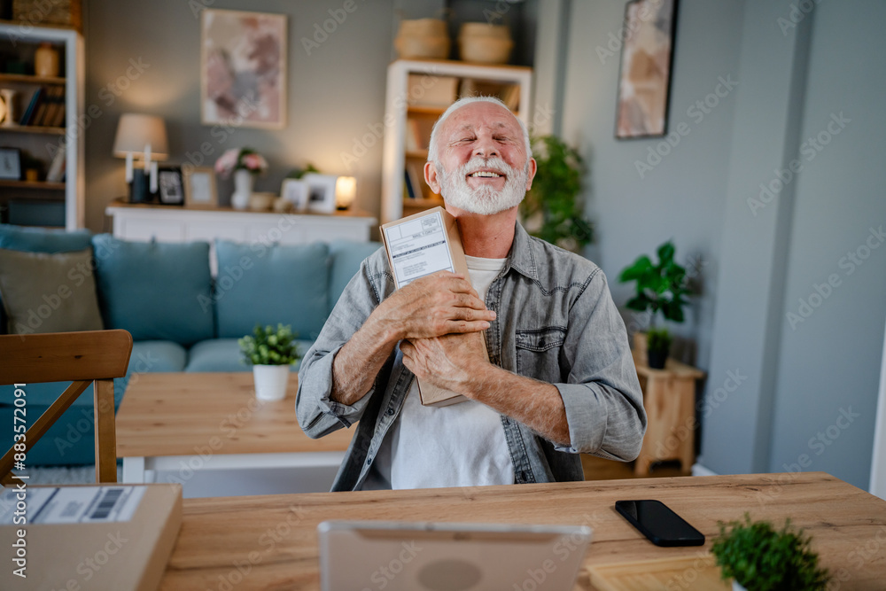 senior man sit at home hold post package delivery present or order senior man sit at home hold post package delivery present or order
