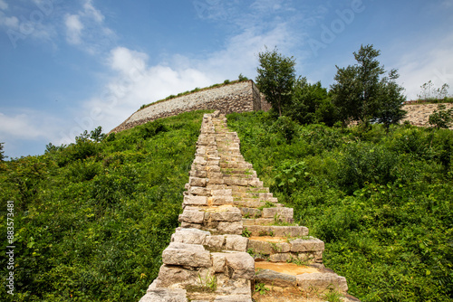 Low angle and summer view of stone steps and fortress on the hill at Gomosanseong Fortress of Sinhyeon-ri near Mungyeong-si, South Korea 