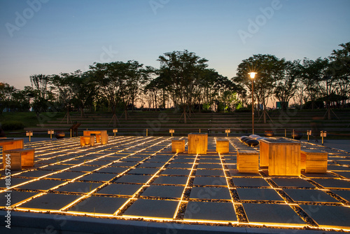 Cheongna International City, Seo-gu, Incheon, South Korea - July 2, 2023: Night view of light on stepping stones of giant checker board with tables at Cheongna Lake Park
 photo