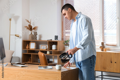 Handsome young man pouring ...