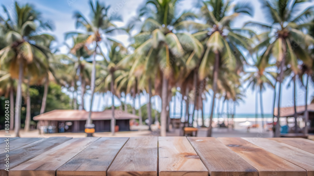 Fototapeta premium Beautiful blurred coconut tree background with rustic wooden table top providing ample copy space for product display and branding design elements.