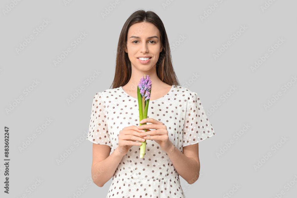 Happy smiling young woman with hyacinth flower on white background
