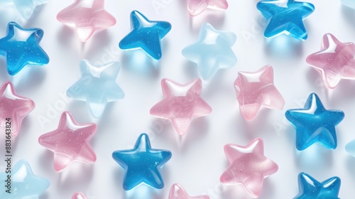 Colorful star-shaped candies in blue and pink on white surface for party decorations.