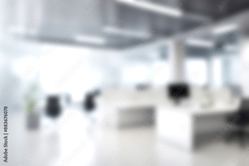 Blur open office with soft sunlight at big window for background usage. blur interior background concept. white and bright tone.