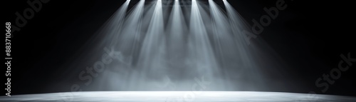 Stage with Dramatic Spotlights beams of light illuminate a foggy stage creating an atmosphere of anticipation and suspense in a dark empty theater