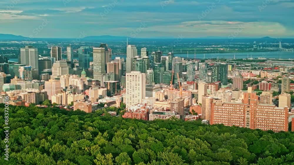 Montreal, Canada - July 12 2024: 4K Drone aerial view of Montreal downtown from hill top of Mont Royal Montreal, Canada - July 12 2024: 4K Drone aerial view of Montreal downtown from hill top of Mont Royal