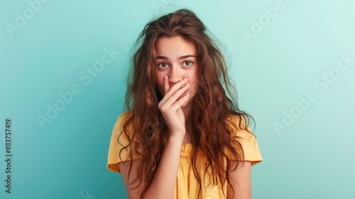 Shy Teenager with Hand Over Mouth in Summer Attire against Solid Color Backdrop