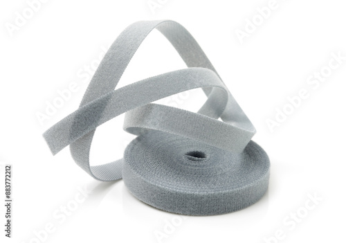 Bild auf Leinwand Gray roll of velcro tape on white background