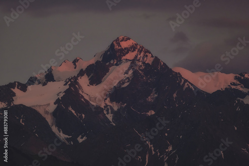 Peak Komsomol or Nursultan or Almatinsky is a beautiful peak in the mountains with glaciers at sunset in the city of Almaty Kazakhstan, Tien Shan Trans-Ili Alatau photo