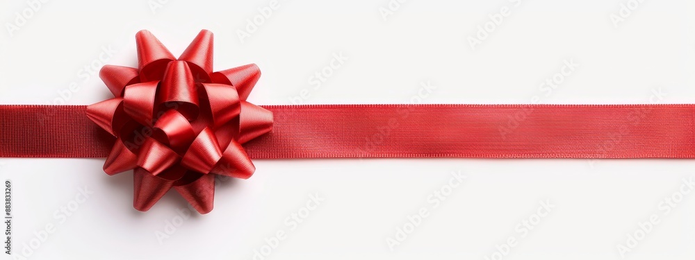 A red ribbon, close-up, against a pristine white background The ribbon ends in a neat bow A red ribbon, close-up, against a pristine white background The ribbon ends in a neat bow